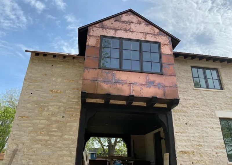 Copper metal panel facade on a stone building for Skylight Installation in Southbury